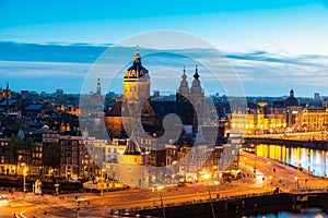 Aerial view of Amsterdam skyline in historical area at night in Amsterdam, Netherlands