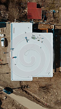 Aerial view of an apartment building with flat roof in construction, ballasted system with geotextile, PVC or EPDM membrane