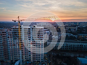 aerial view of apartment construction site with crane