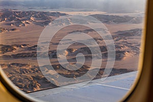 Aerial view on arabian desert and Red sea mountains from the airplane window