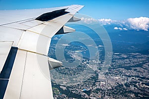 Aerial view of the area of Coquitlam near Vancouver Canada and the wing of a plane