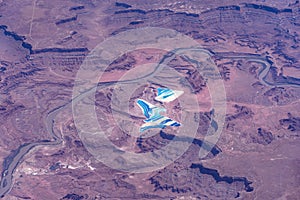 Aerial view around the Colorado River near Moab Utah in the Rocky Mountains  with Potash evaporation ponds shining bright blue