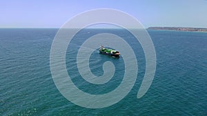 Aerial view of the arrival in the vicinity of the port of Alicante, the container ship JSP Rover.