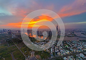 Aerial view of Asia city at sunset by drone with Landmark 81 skycraper modern building, boat on Saigon river, night skyline of photo