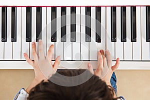 Aerial view of Asian Chinese little boy playing piano