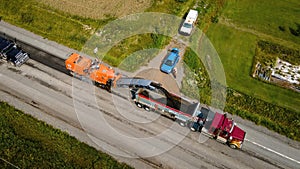 Aerial view of an asphalt planer and a dump truck