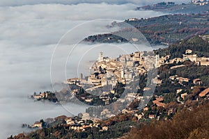 Aerial view of Assisi Umbria Italy above a sea of fog