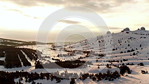 Aerial view of the astrophysical observatory in wintertime in snowy forest, Crimea. Shot. Beautiful landscape of snowy