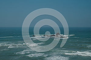 Aerial view of Atlantic Ocean from Legzira Beach. Rock formations in the middle of wild waves. Landmark in Tiznit Province.