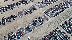 Aerial view of auction reseller company big parking lot with parked cars ready for remarketing services. Sales of