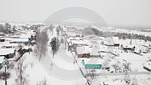 Aerial view authentic countryside village settlement infrastructure old wooden house winter snow