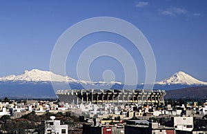 Aerial view of Aztec stadium with snowed volcanoes in Mexico City
