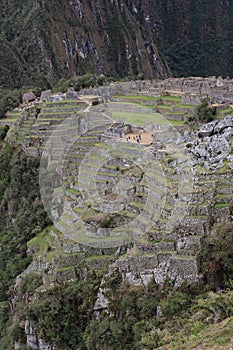 An aerial view of the back section of Machu Picchu, including farming terraces, the main temple and Intihuatana