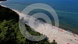 Aerial view of Baltic Sea beach with swimming people in Wladyslawowo, Poland