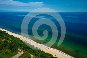 Aerial view of Baltic Sea beach with swimming people in Wladyslawowo, Poland