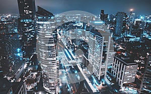 Aerial view of Bangkok city at night in Thailand. cityscape of Modern buildings, urban architecture and road traffic