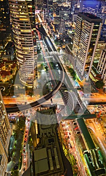 Aerial view of Bangkok city at night in Thailand. cityscape of Modern buildings, urban architecture and road traffic