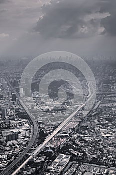 Aerial view of Bangkok, Thailand, polluted air over the horizon. Urban sprawl, metropolis. Black and white color toned vintage eff