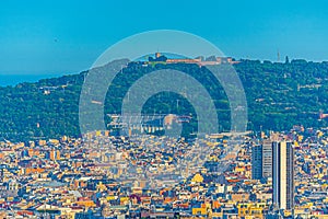Aerial view of Barcelona with Montjuic hill on background, Spain