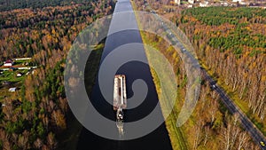 Aerial view:Barge on the river. Autumn landscape, river canal near the forest.