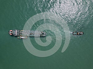 Aerial view of a barge and tugboat.
