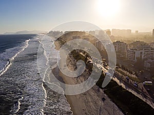 Aerial view of Barra da Tijuca beach during late afternoon with hazy sky and golden light. Rio de Janeiro, Brazil.