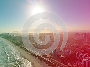 Aerial view of Barra da Tijuca beach during late afternoon with hazy sky and golden light. Rio de Janeiro, Brazil