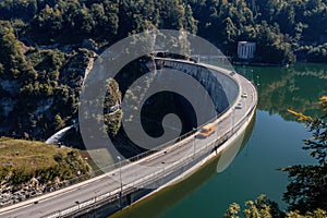 Aerial view of the Barrage de Rossens, a dam in the canton of Fribourg, Switzerland. Six vehicles are passing on the