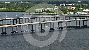 Aerial view of Barron Collier Bridge and Gilchrist Bridge in Florida with moving traffic. Transportation infrastructure