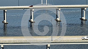 Aerial view of Barron Collier Bridge and Gilchrist Bridge in Florida with moving traffic. Transportation infrastructure