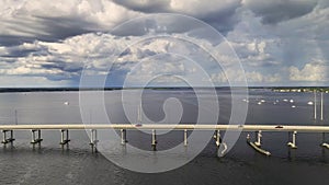 Aerial view of Barron Collier Bridge and Gilchrist Bridge in Florida with moving traffic. Transportation infrastructure