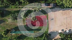 Aerial View of basketball court in a nature environment. Sunset summer day in recreation community part. Drone video of