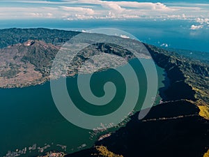 Aerial view of Batur volcano with lake and sea in Bali