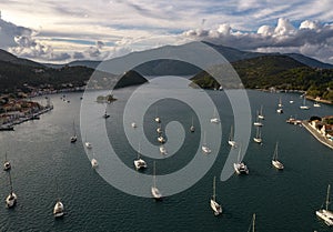 Aerial view of a bay with sailing boats at sunset