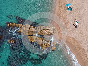 Aerial view of beach with cliff and sea in Costa Brava