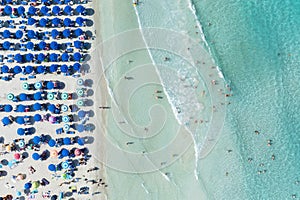 Aerial view on beach, people and umbrellas. Vacation and adventure.
