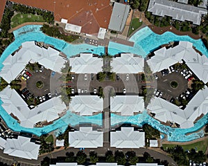 Aerial view of a beach resort with swimming pool and multiple buildings