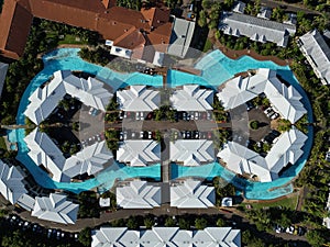 Aerial view of a beach resort with swimming pool and multiple buildings