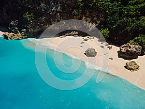 Aerial view of beach with stones, rocks and blue ocean in Hawaii