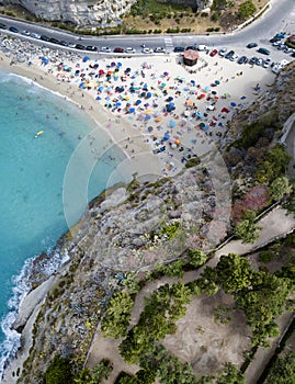 Aerial view of a beach with umbrellas and bathers. Tropea, Calabria, Italy