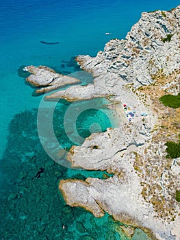 Aerial view of beach umbrellas at Praia I Focu against the sea in Calabria, Italy