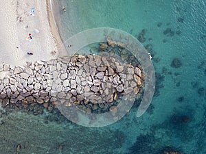 Aerial view of a beach and umbrellas. Tropea, Calabria, Italy. Parghelia. Beach and rocks of Lido La scogliera