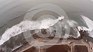 Aerial view of the beach and the waves. Slow action