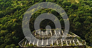 Aerial view of beautiful ancient fortress in forest in summer. Tarakaniv Fort.