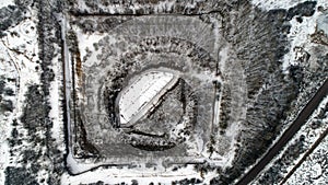 Aerial view of beautiful ancient fortress in forest in winter. Tarakaniv Fort.