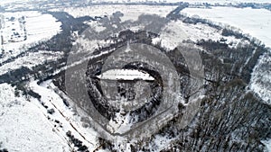 Aerial view of beautiful ancient fortress in forest in winter. Tarakaniv Fort.