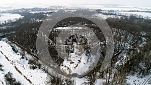 Aerial view of beautiful ancient fortress in forest in winter. Tarakaniv Fort.