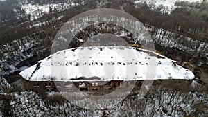 Aerial view of beautiful ancient fortress in forest in winter. Tarakaniv Fort.