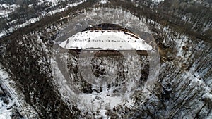 Aerial view of beautiful ancient fortress in forest in winter. Tarakaniv Fort.