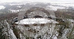 Aerial view of beautiful ancient fortress in forest in winter. Tarakaniv Fort.